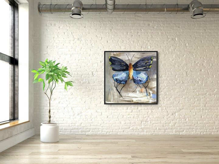 A gallery shot of Blue, a butterfly / moth collage created with recycled magazine bits embellished with delicate hand stitching. Museum-quality wall art.