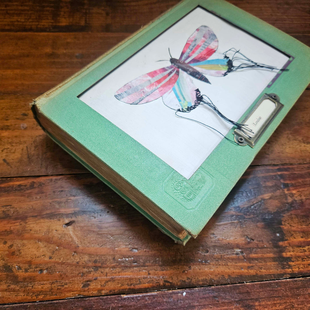 Handmade butterfly moth collage in a vintage book frame. Eco-friendly wall art made from recycled magazines. A unique gift for nature lovers.