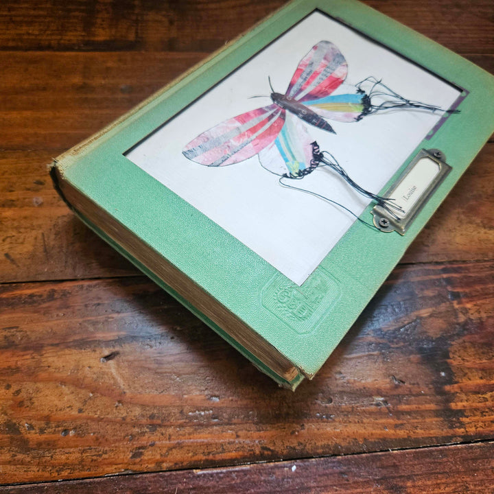 Handmade butterfly moth collage in a vintage book frame. Eco-friendly wall art made from recycled magazines. A unique gift for nature lovers.