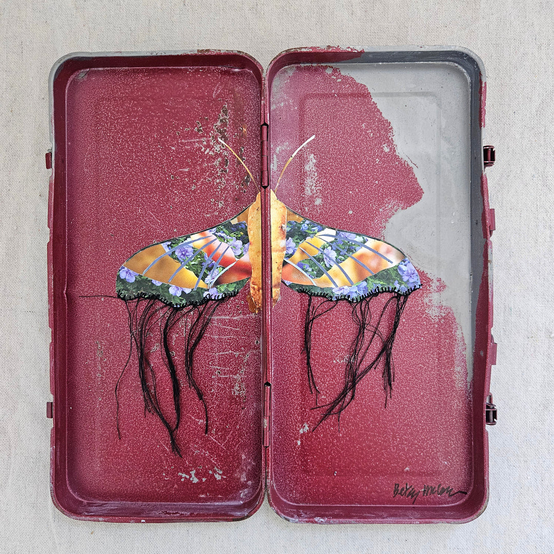 butterfly collage artwork made from recycled magazine pages and set into a toolbox
