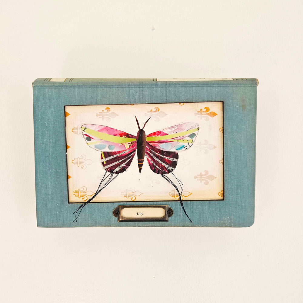 Lily is a handmade butterfly moth collage in a vintage book frame. Eco-friendly wall art made from recycled magazines. A unique gift for nature lovers.